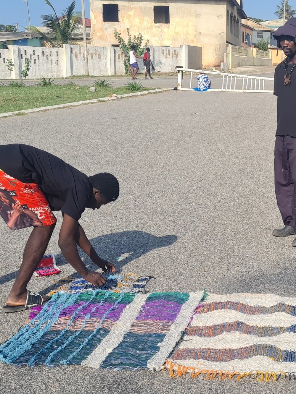 Reclaimed-fabric rugs laid out and pieced together by hand